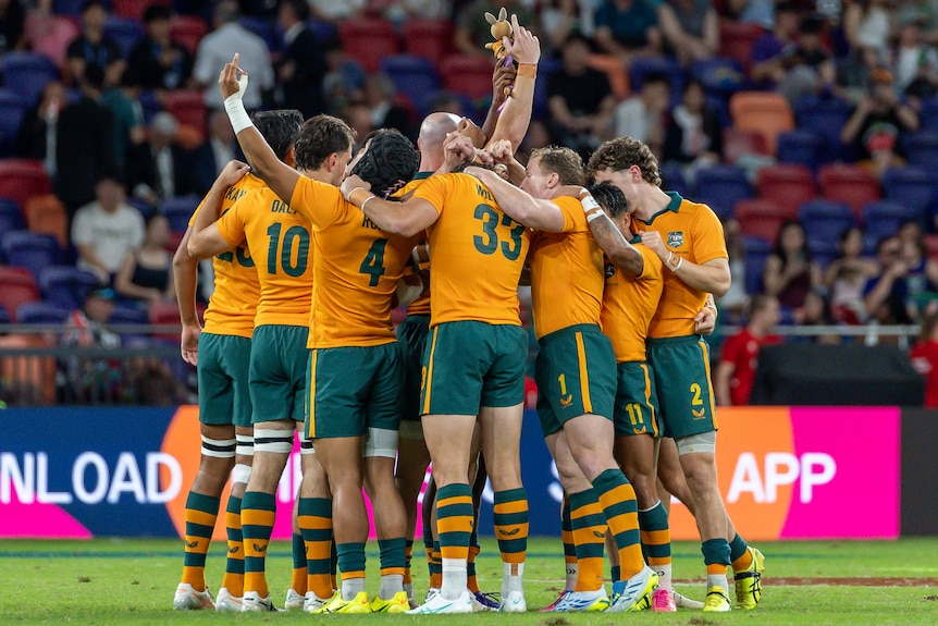 Australia in a huddle before a men's rugby sevens match in Hong Kong.