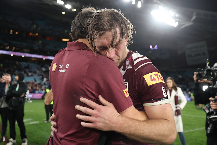 A tearful Queensland coach Billy Slater hugs skipper Cameron Munster after this year's Origin decider.