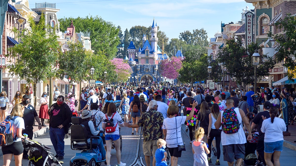 Visitors walk up Main Street U.S.A. at Disneyland in Anaheim, Calif.