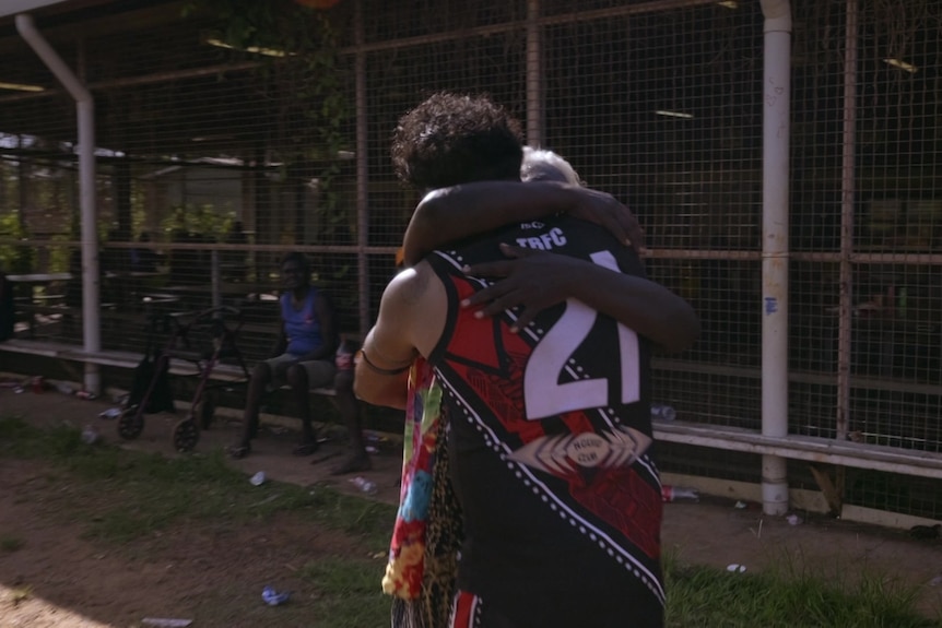 Willie Rioli in his team uniform hugging his mother off the field.