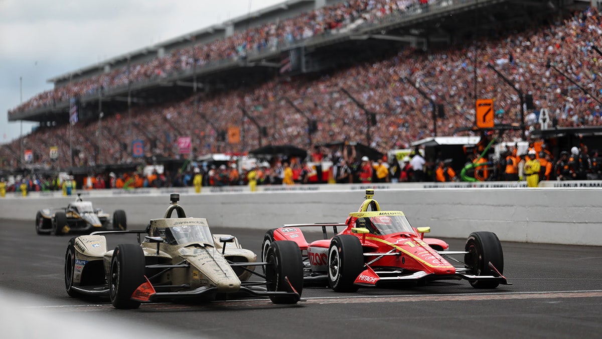 Felix Rosenqvist driving car number 60 crossing finish line at Indianapolis Motor Speedway