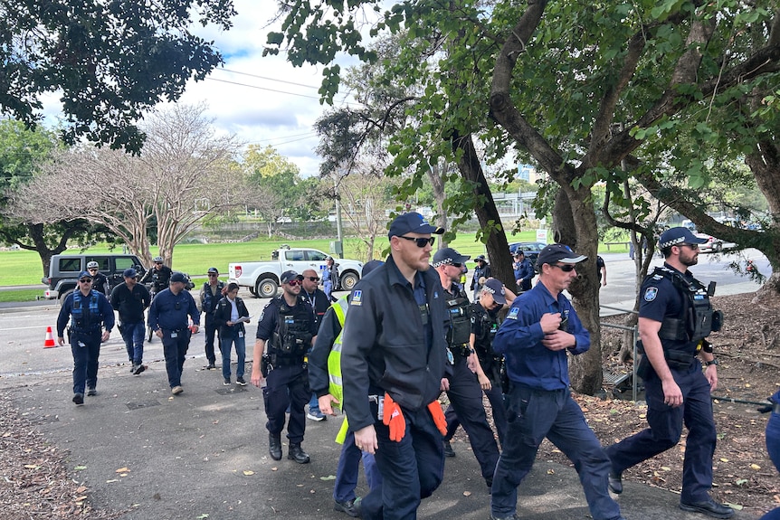 A group of police officers walking through Victoria Park