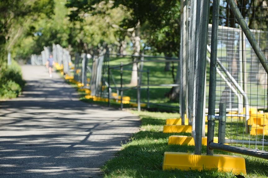 Temporary fencing next to a path in Brisbane's Victoria Park.