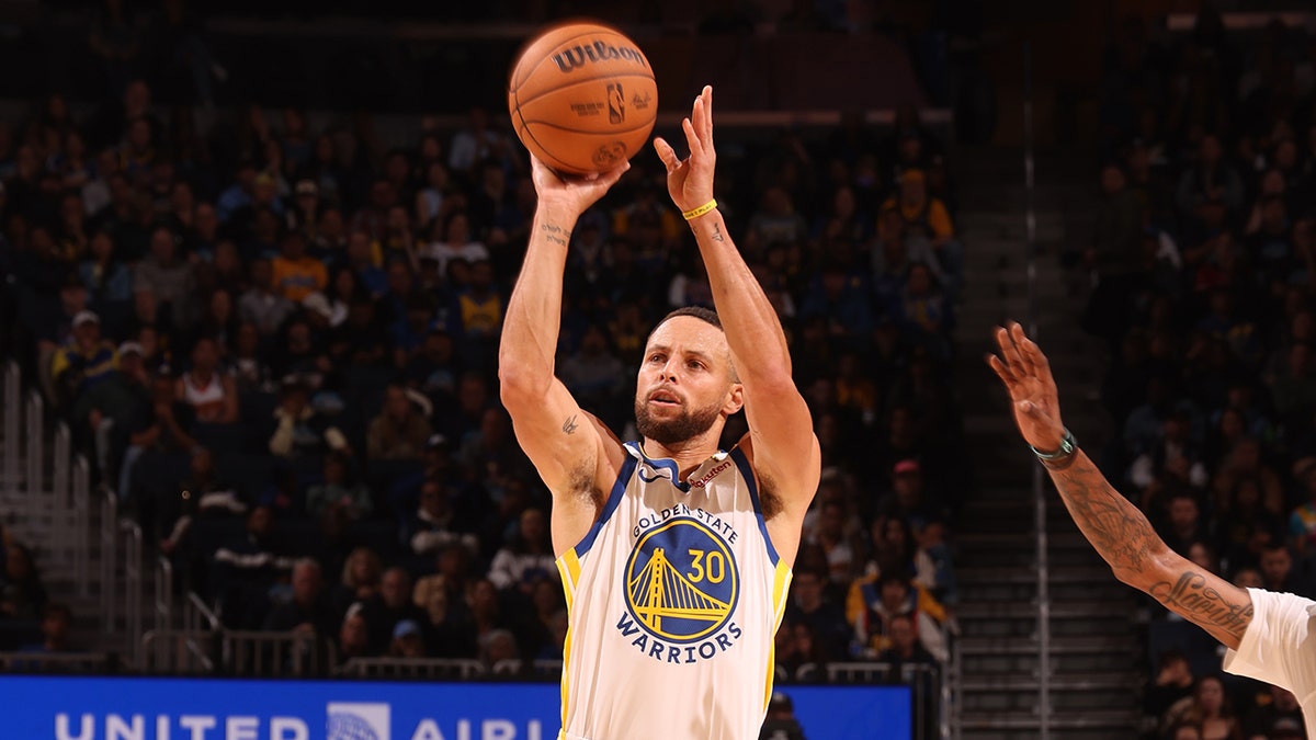 Stephen Curry shooting a three-point basket during a basketball game at Chase Center